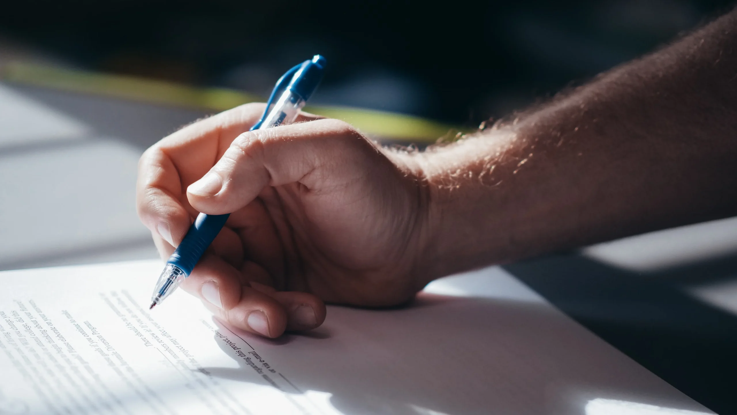 Close-up of an executive using a pen to sign a commercial non-disclosure agreement.